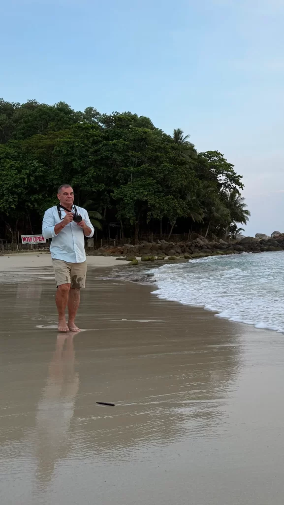 David Hibbins photographing the shoreline at Freedom Beach in Phuket Thailand